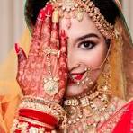 Makeup artist applying wedding makeup to bride.